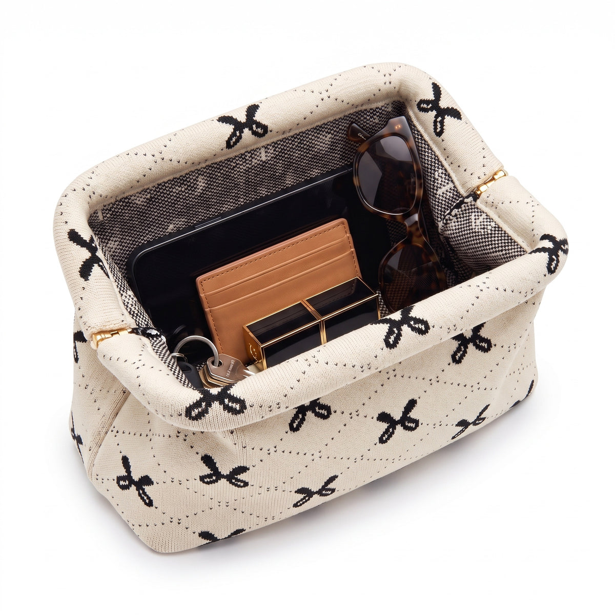 Cream Bow Cloud Pouch shown open with everyday items inside