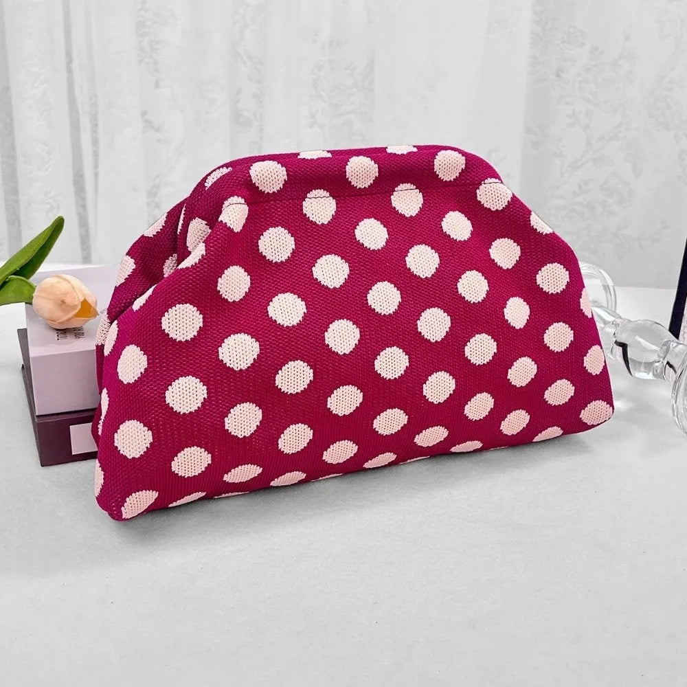 Magenta Polka Dot Cloud Clutch styled on a table