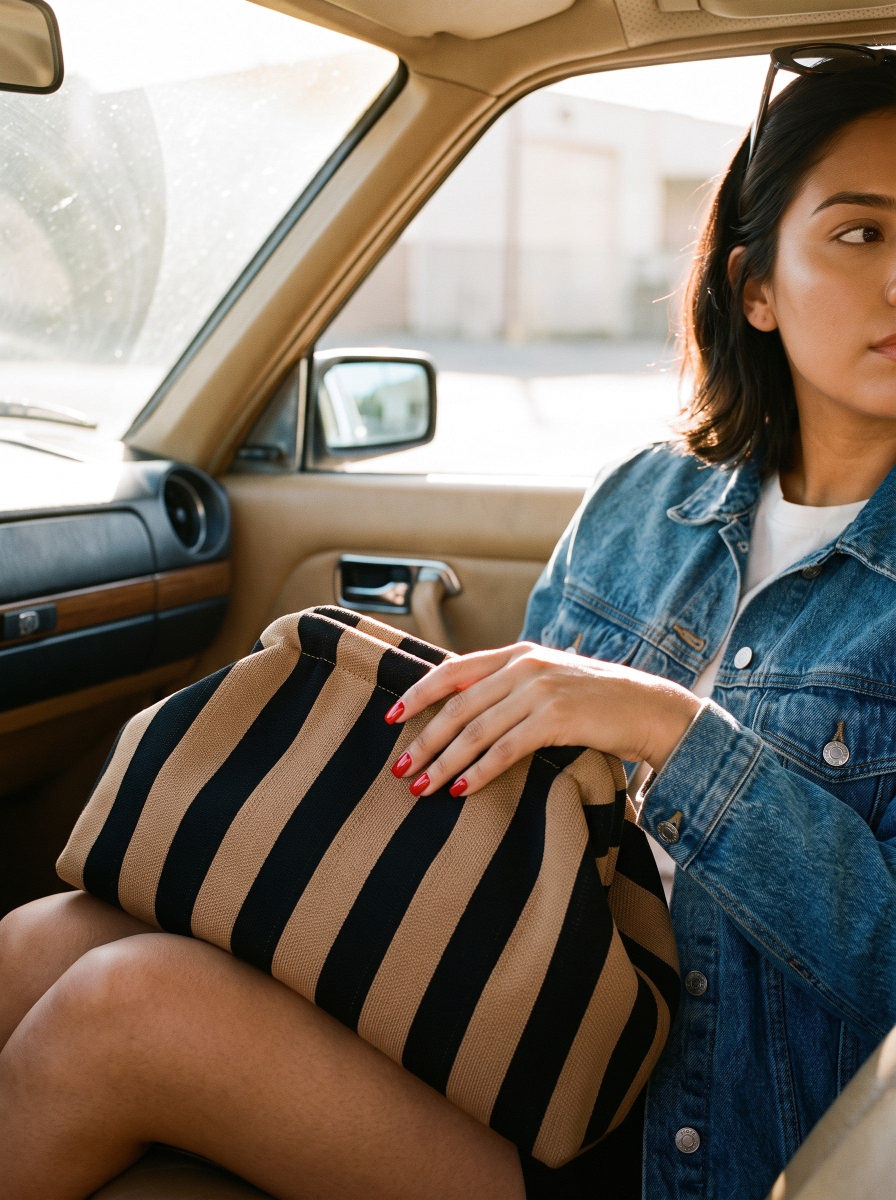 Camel stripe clutch in a vintage car