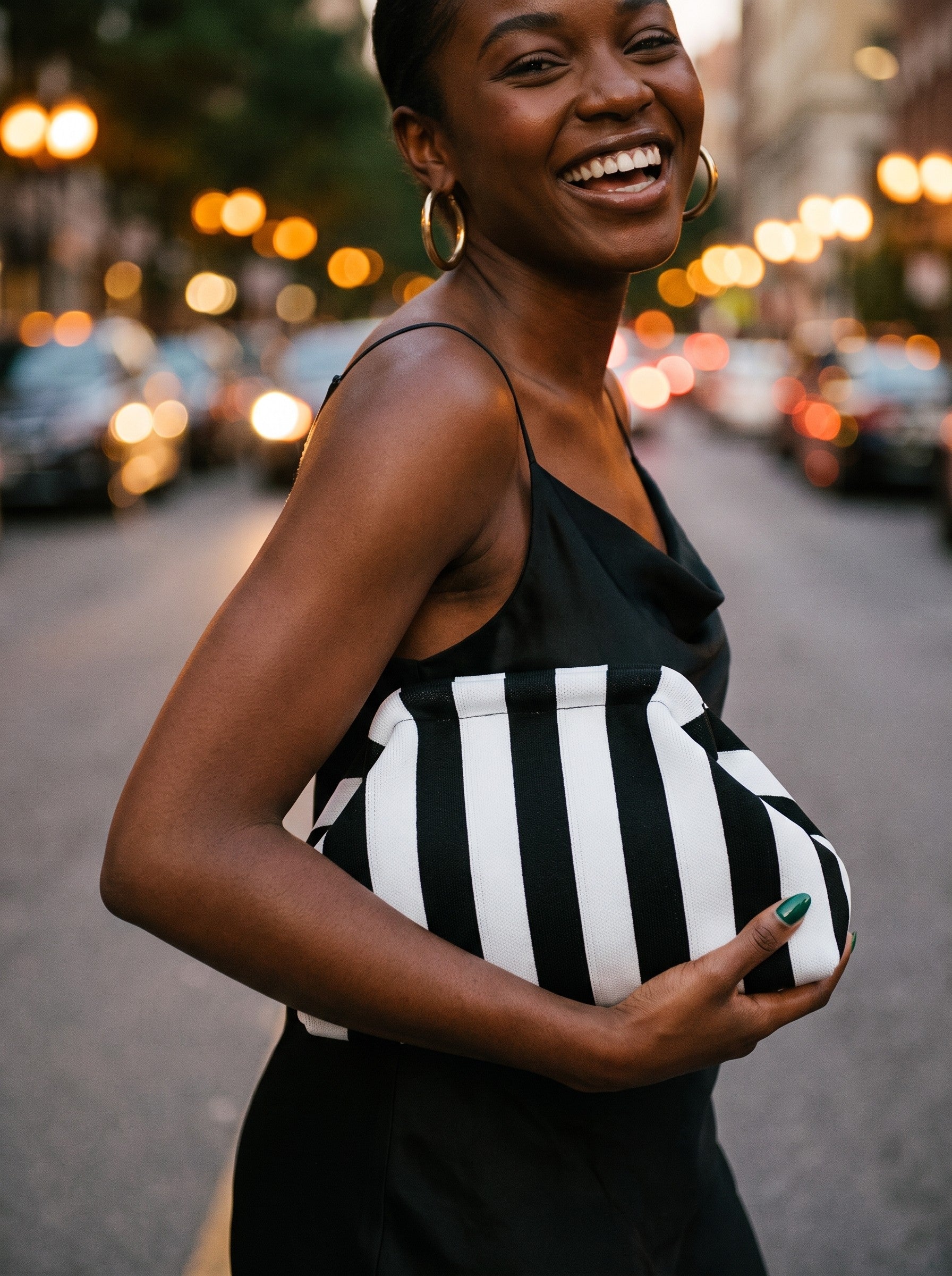 Monochrome stripe clutch carried at dusk